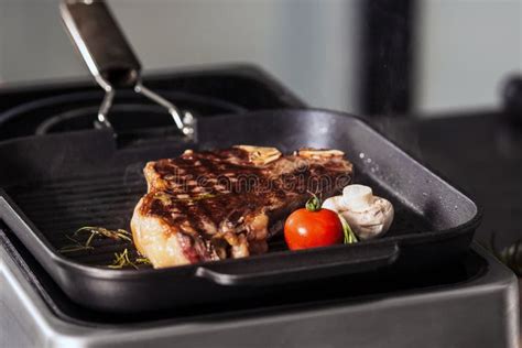 Grill Steak at Griddle Pan. Closeup Smoked Beef with Tomato and ...