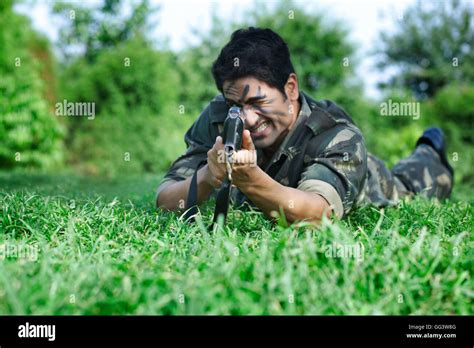 Army Soldier Aiming With Rifle While Lying On Grass Stock Photo Alamy