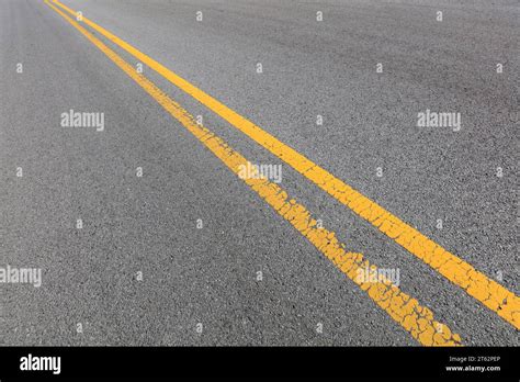 Yellow Double Solid Line On The Asphalt Road Stock Photo Alamy