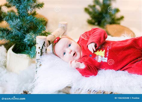 Cute Newborn Baby In A Christmas Costume On A Wooden Bed Stock Photo