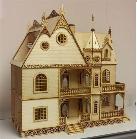 A Wooden Model Of A Doll House With Gold Trimmings And Balconies