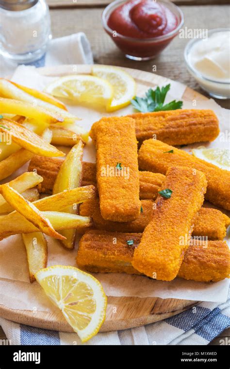 Fried Fish Sticks With French Fries Fish Fingers Over Wooden