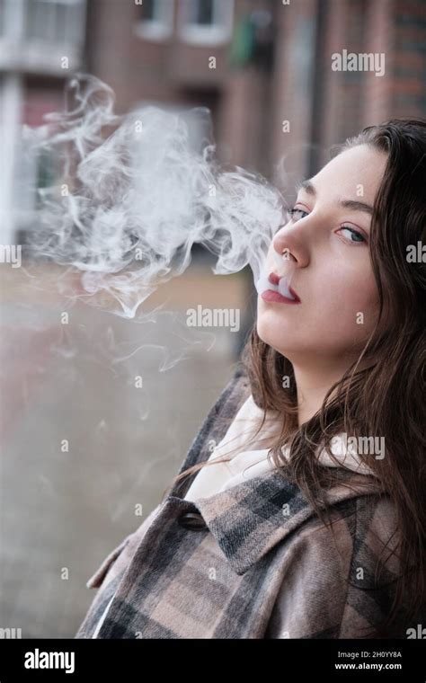 Young Woman On City Street Exhale Smoke Closeup Portrait Stock Photo