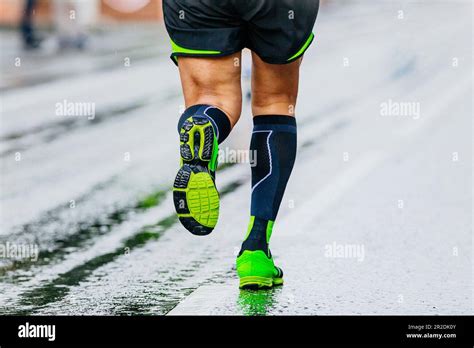 Close Up Legs Runner Athlete Running Marathon In Black Compression