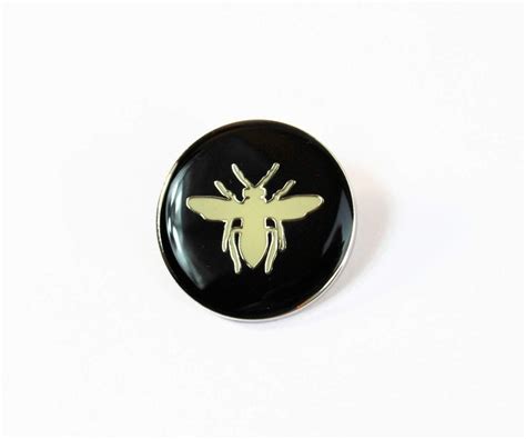 Dior Bee Pin With Black Background And White Bee