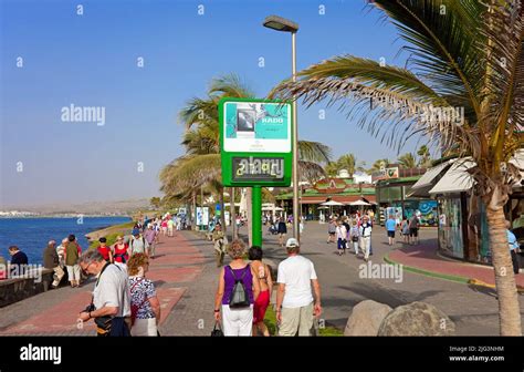 Tourists On The Paseo De Meloneras Sea Promenade At Maspalomas Grand