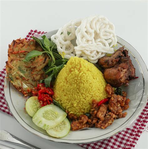 Nasi Kuning Or Yellow Rice In Cone Shape Indonesian Festive Rice Dish Presentation With Some