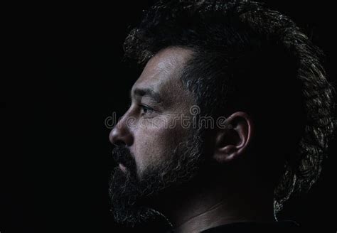 Profile Of Man With Crest Hairstyle And Goatee Beard Stock Photo