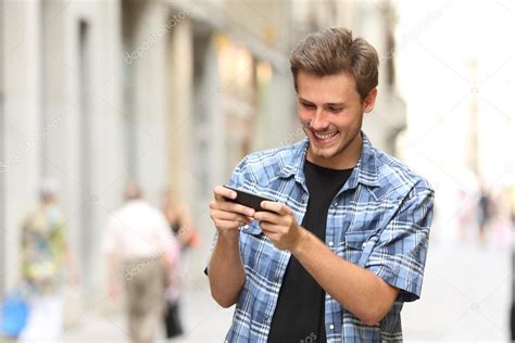 Man playing game with a smart phone — Stock Photo © AntonioGuillemF ...