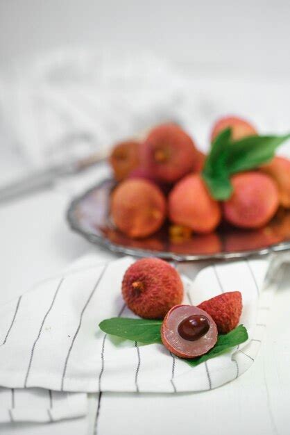 Premium Photo Fresh Ripe Lychee Fruit And Peeled Lychee With Green