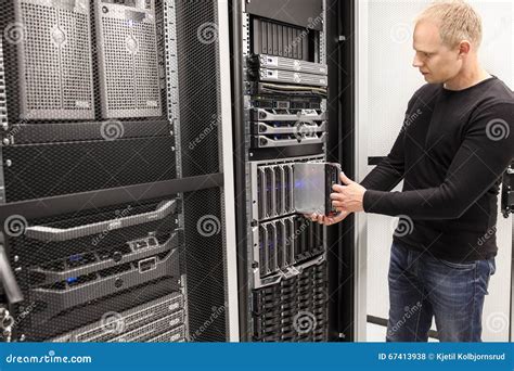 It Consultant Install Blade Server In Large Datacenter Stock Photo