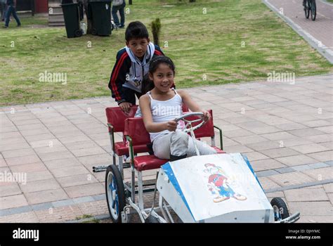 Two children playing in a go-cart Stock Photo - Alamy