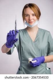 Portrait Attractive Female Dentist Holding Syringe Stock Photo