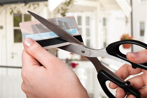 Premium Photo Cutting Up Credit Card With Scissors