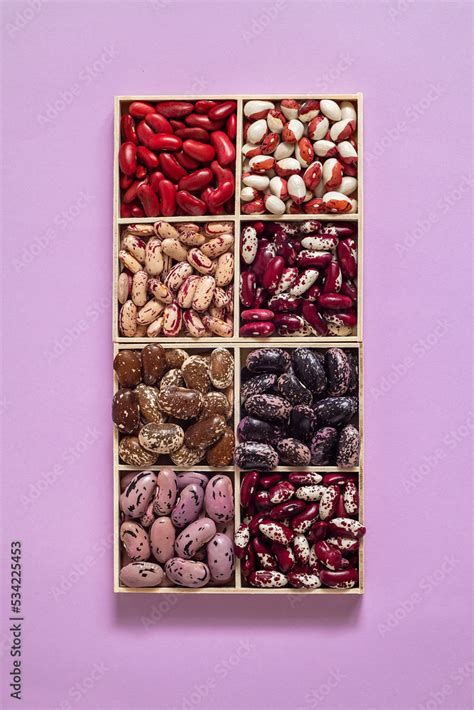 Two Sets Of Organic Beans In A Wooden Boxes On A Pink Background