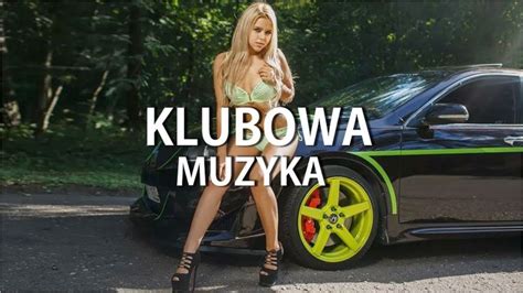 A Woman Standing Next To A Car With The Words Kumbowa Muzzyka On It