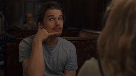 A Man Sitting At A Table In Front Of A Woman