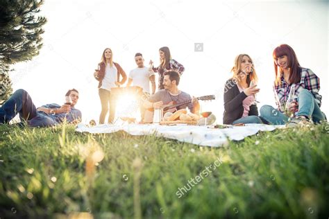 Stock Photo Group Of Friends Having Pic Nic In A Park On A Sunny Day