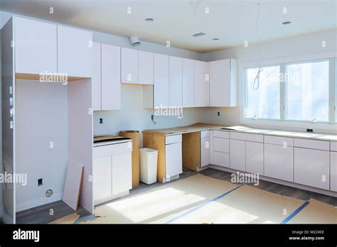 Installing new induction hob in modern kitchen kitchen Installation of kitchen cabinet Stock ...