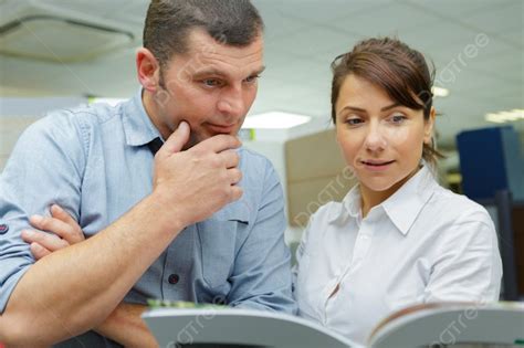 Portrait Of Two People Checking Finances Book Photo Background And