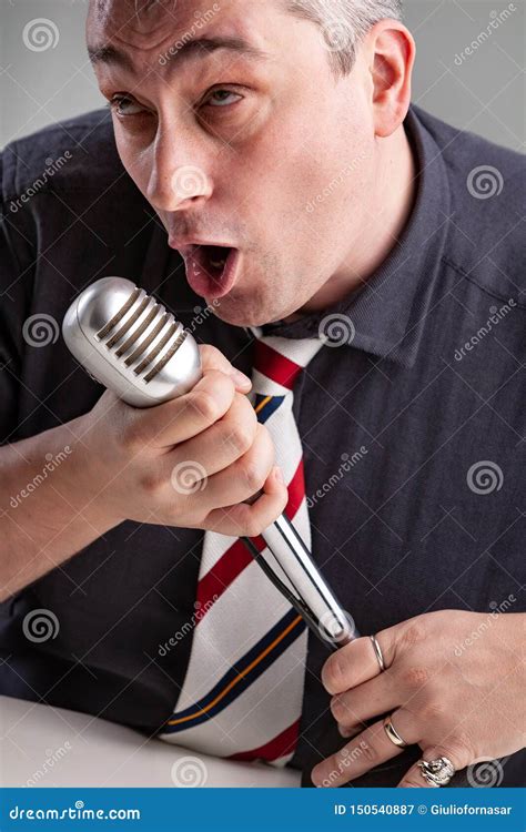 Man Engrossed In His Music Holding A Microphone Stock Image Image Of