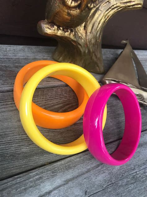 A Grouping Of 3 Cheerful Resort Citrus Rainbow Colored Plastic Bangle