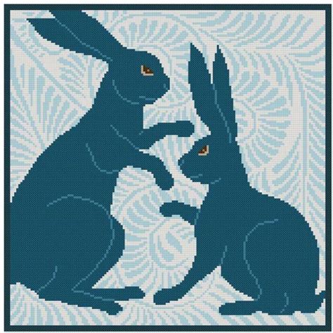 The Cross Stitch Pattern Shows An Image Of Two Rabbits One Sitting And