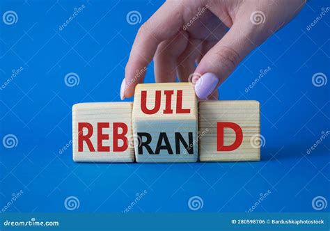 Rebuild And Rebrand Symbol Businessman Hand Turns Wooden Cubes And