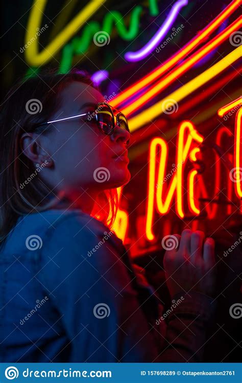 Creative Portrait Of A Girl In Neon Lighting With Glasses Stock Image