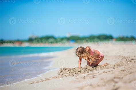 Little girl at tropical white beach making sand castle 30199725 Stock ...