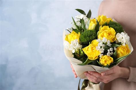 Woman With Bouquet Of Beautiful Tulips On Light Blue Background