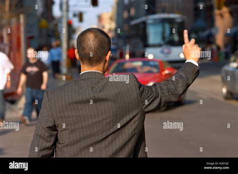 Man Dressed In Suit Is Hailing A Cab Stock Photo Alamy