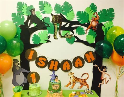 A Jungle Themed Birthday Party With Green And Orange Balloons