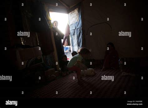 In This Wednesday Oct 23 2013 Photo A Syrian Woman Stands In The Doorway Of Her Makeshift