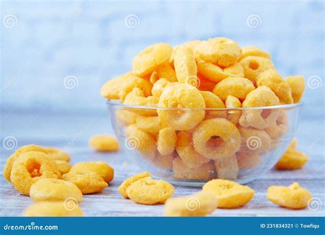 Puffed Corn Rings Chips In Black Bowl On White Background Stock Image