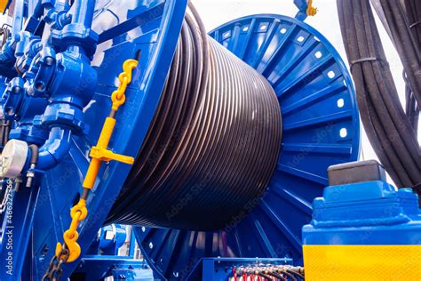 Hose Or Electrical Cable Is Coiled Around Giant Spool Concept