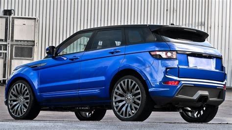 A Blue Range Rover Parked In Front Of A Building