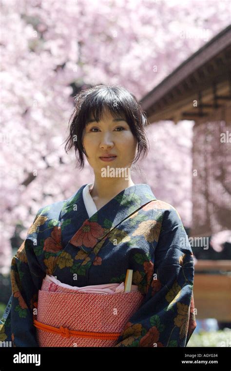 Portrait Of A Japanese Woman Wearing Kimono Cherry Blossom Background