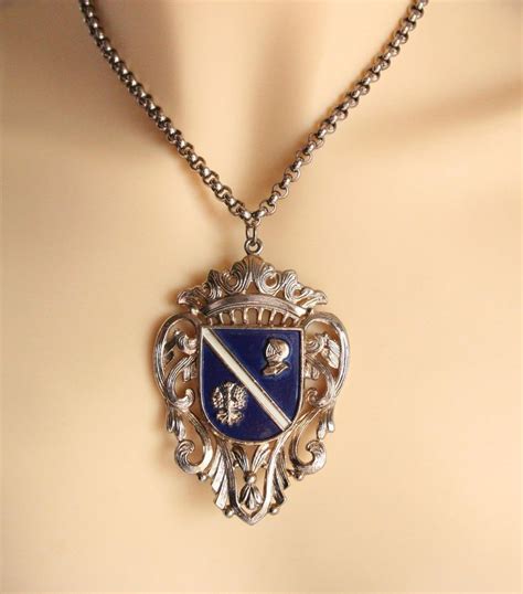 A Necklace With A Blue And White Crest On It