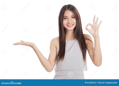 Beautiful Young Asian Woman Show Palm Hand And Ok Sign Stock Photo