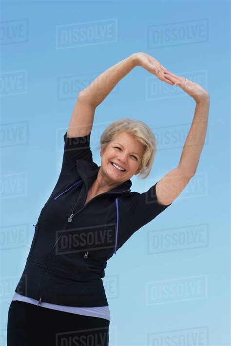 Mature Woman Exercising Outdoors Stock Photo Dissolve