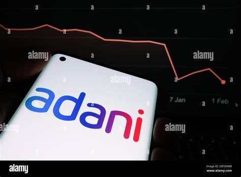 Adani Group logo seen on the smartphone screen and company stock price ...