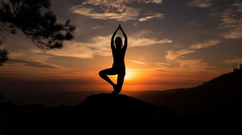 Premium AI Image | A woman doing yoga on a mountain at sunset