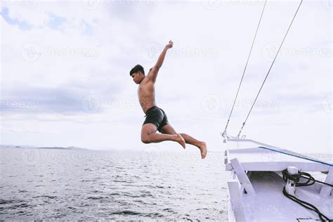 Brave Man Jumping Into The Sea From A Boat Stock Photo At Vecteezy