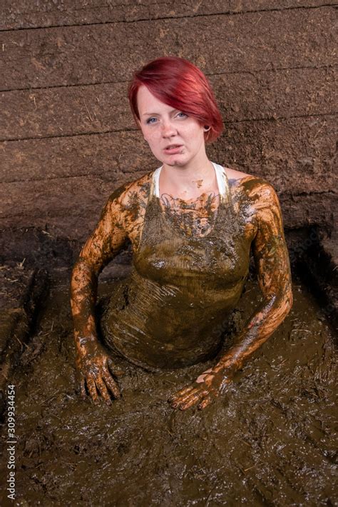 Girl Bathing in cow manure in a manure channel Stock Photo | Adobe Stock