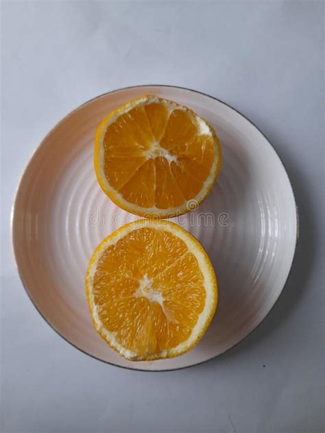 Sliced Fresh Juicy Orange On Plate Isolated On White Background Stock