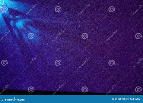 On A Dark Purple Gradient Background Scattered Light Blue Rays Of