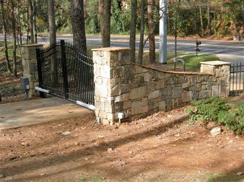 Automated Gate System With Stone Walls Driveway Entrance