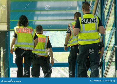 Policewoman And Policemen On Duty Wearing Surgical Face Masks While