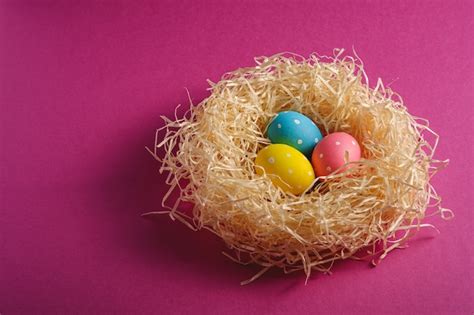 Premium Photo Colorful Polka Dot Easter Eggs In Wooden Nest On Pink